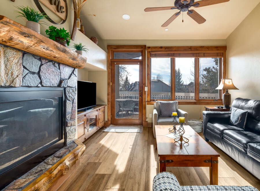 Step into luxury with this stunning living room, featuring a cozy fireplace and a sleek entertainment center.