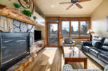 Step into luxury with this stunning living room, featuring a cozy fireplace and a sleek entertainment center.