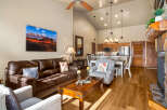 This stunning living space boasts a cozy ambiance with its inviting leather sofa and charming accent pillows.