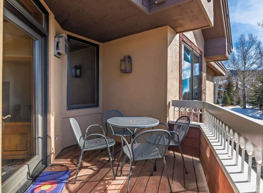 Enjoy the fresh mountain air from this charming balcony! This outdoor space features a cozy table and chairs, perfect for morning coffee or evening relaxation.