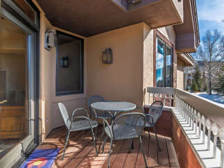Enjoy the fresh mountain air from this charming balcony! This outdoor space features a cozy table and chairs, perfect for morning coffee or evening relaxation.