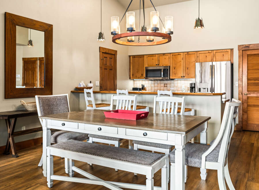 This stunning dining area features a beautiful wooden table and chairs, perfect for family meals or entertaining guests.