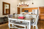 This stunning dining area features a beautiful wooden table and chairs, perfect for family meals or entertaining guests.