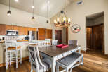 This stunning dining area features a rustic wooden table, perfect for family gatherings.