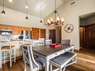 This stunning dining area features a rustic wooden table, perfect for family gatherings.