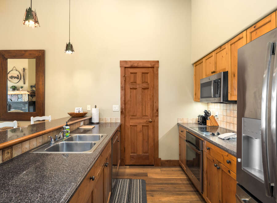 This stunning kitchen boasts a modern design with beautiful wooden cabinetry and sleek countertops.
