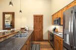 This stunning kitchen boasts a modern design with beautiful wooden cabinetry and sleek countertops.