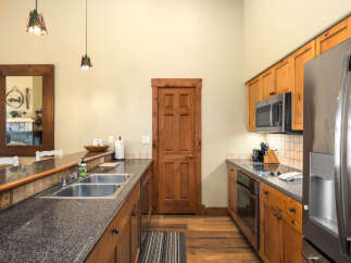 This stunning kitchen boasts a modern design with beautiful wooden cabinetry and sleek countertops.