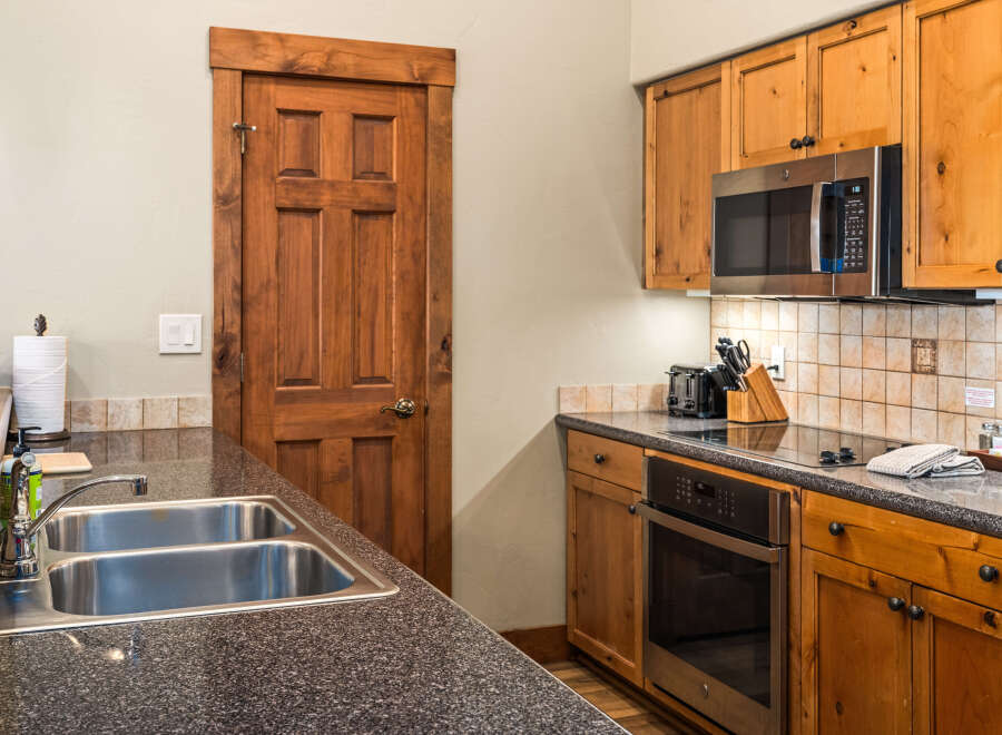 This stunning kitchen boasts beautiful wooden cabinetry and a sleek, modern design.