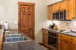 This stunning kitchen boasts beautiful wooden cabinetry and a sleek, modern design.
