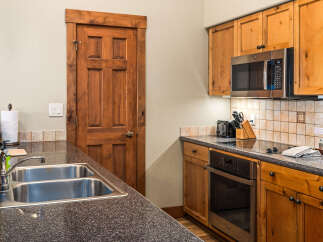 This stunning kitchen boasts beautiful wooden cabinetry and a sleek, modern design.