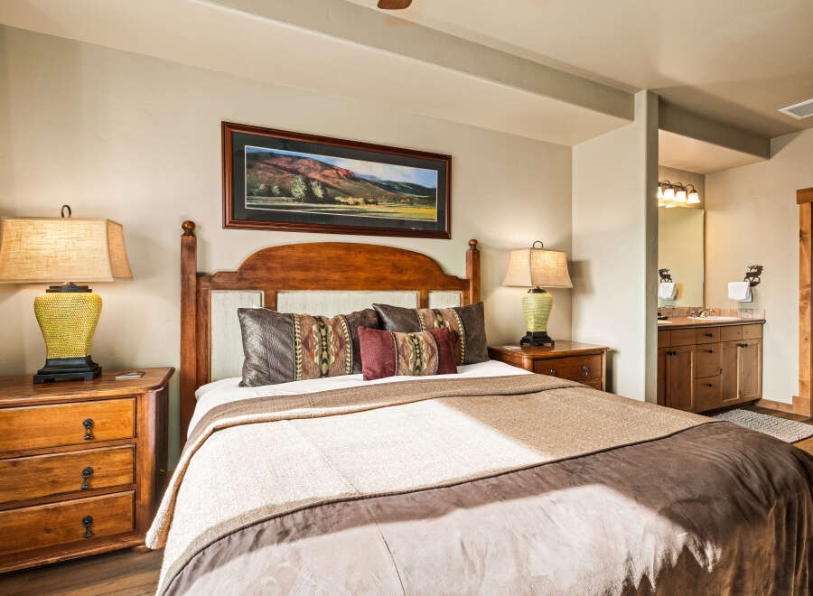 This inviting bedroom showcases a blend of rustic charm and modern comfort.