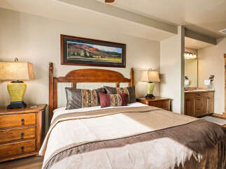 This inviting bedroom showcases a blend of rustic charm and modern comfort.