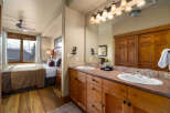 This stunning bathroom features a double vanity with ample counter space and stylish wooden cabinetry.