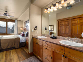 This stunning bathroom features a double vanity with ample counter space and stylish wooden cabinetry.