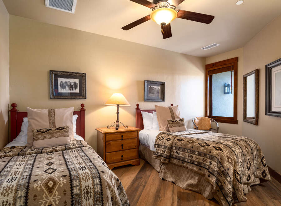 This cozy bedroom features two twin beds, perfect for guests or family members.