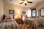 This cozy bedroom features two twin beds, perfect for guests or family members.