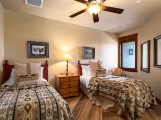 This cozy bedroom features two twin beds, perfect for guests or family members.