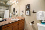 This charming bathroom features a rustic design with wooden cabinetry and a stylish countertop.