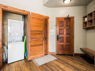 Step into this inviting entryway featuring a stacked washer and dryer, perfect for convenient laundry days.