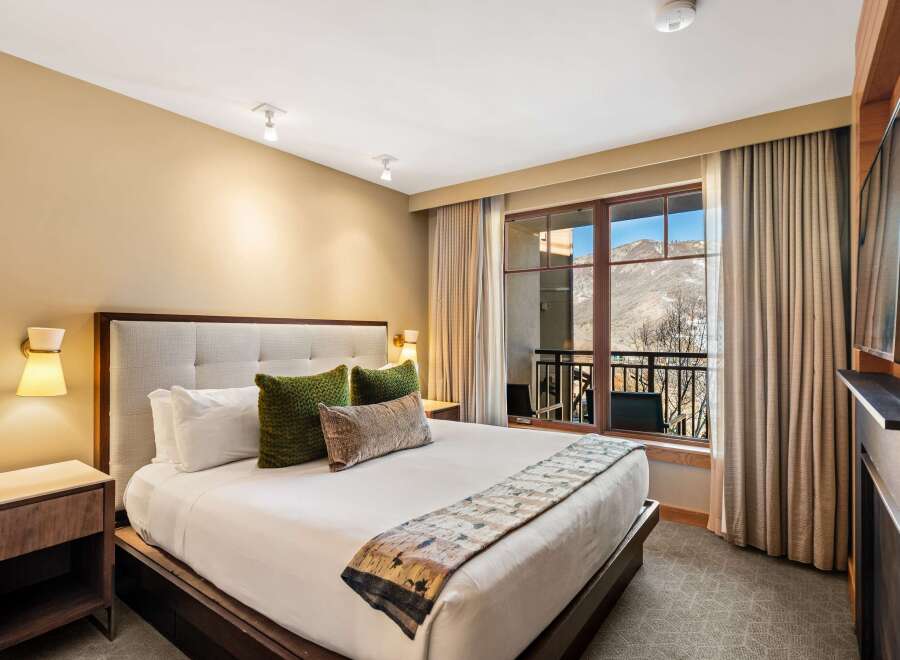 Experience luxury in this stunning bedroom featuring a plush king-sized bed, perfect for a restful night's sleep.