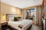 Experience luxury in this stunning bedroom featuring a plush king-sized bed, perfect for a restful night's sleep.