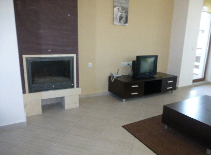 Cozy living room with fireplace and flat-screen TV.
