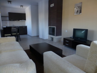 Cozy apartment featuring a comfortable living room with beige sofas and a coffee table, perfect for relaxation.