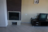 Cozy fireplace and modern TV stand enhance this comfortable living space.