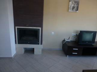 Cozy fireplace and modern TV stand enhance this comfortable living space.