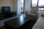 Cozy living room with a comfortable armchair and sofa, perfect for relaxing after a day of exploring.