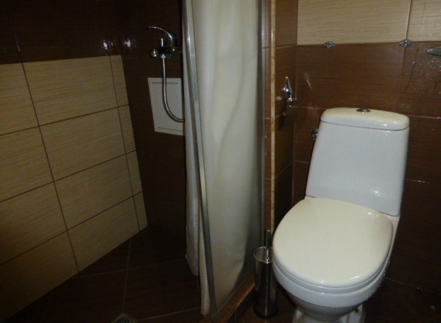 This cozy bathroom boasts modern fixtures and a clean aesthetic.