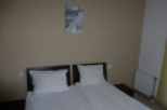 Cozy hotel room featuring two comfortable twin beds, perfect for a relaxing stay.