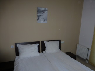 Cozy hotel room featuring two comfortable twin beds, perfect for a relaxing stay.