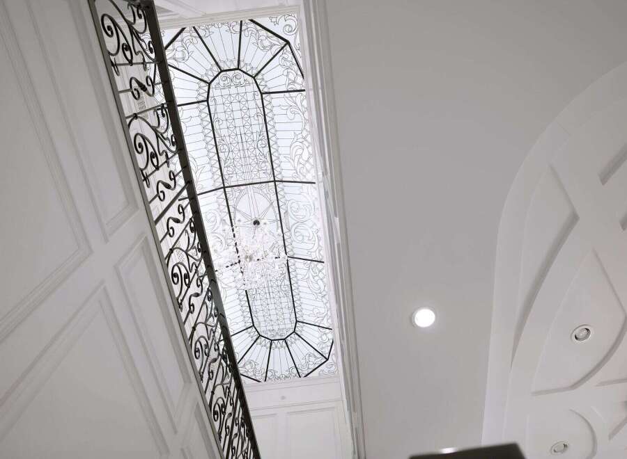 Experience luxury living with this stunning property featuring a grand staircase and exquisite architectural details.