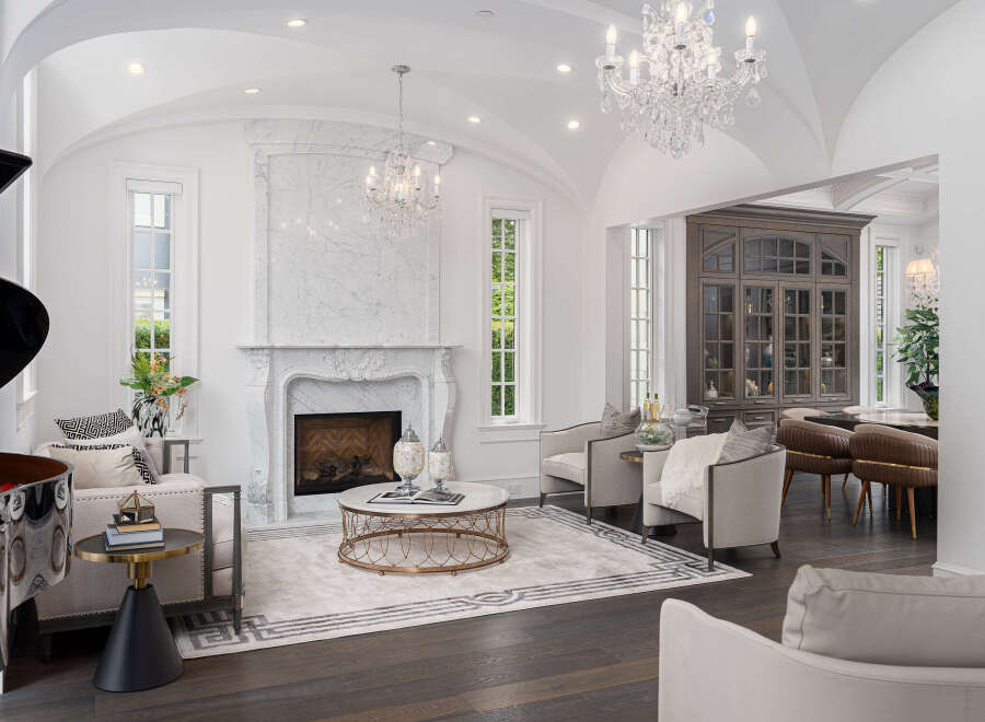 Step into luxury with this stunning property, featuring an elegant living room with a grand piano and a marble fireplace.
