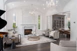 Step into luxury with this stunning property, featuring an elegant living room with a grand piano and a marble fireplace.