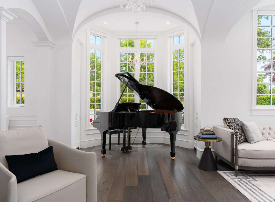 Experience luxury living in this stunning property featuring a grand piano, perfect for music enthusiasts.
