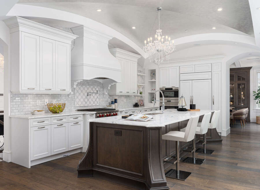 Experience luxury living in this stunning kitchen! Featuring a spacious island with seating, high-end appliances, and elegant white cabinetry, this kitchen is perfect for both cooking and entertaining.