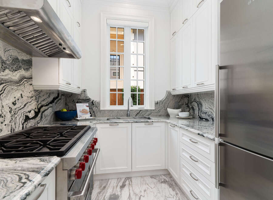 This stunning kitchen boasts a sleek, modern design with high-end appliances and finishes.