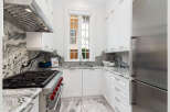 This stunning kitchen boasts a sleek, modern design with high-end appliances and finishes.