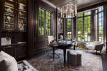 Step into luxury with this stunning home office, featuring rich wood paneling and abundant natural light.