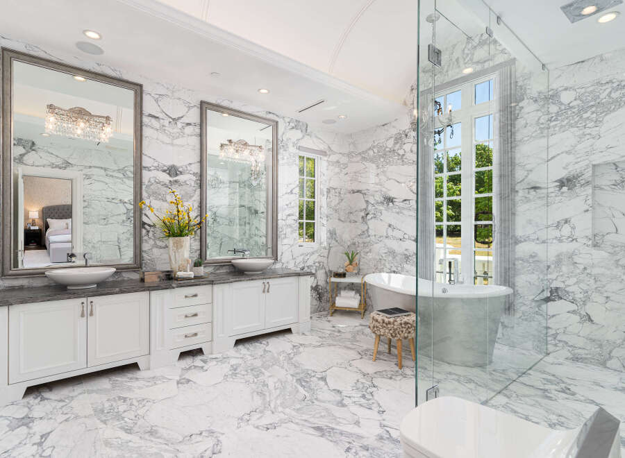 Step into luxury with this stunning bathroom featuring exquisite marble finishes and elegant design.