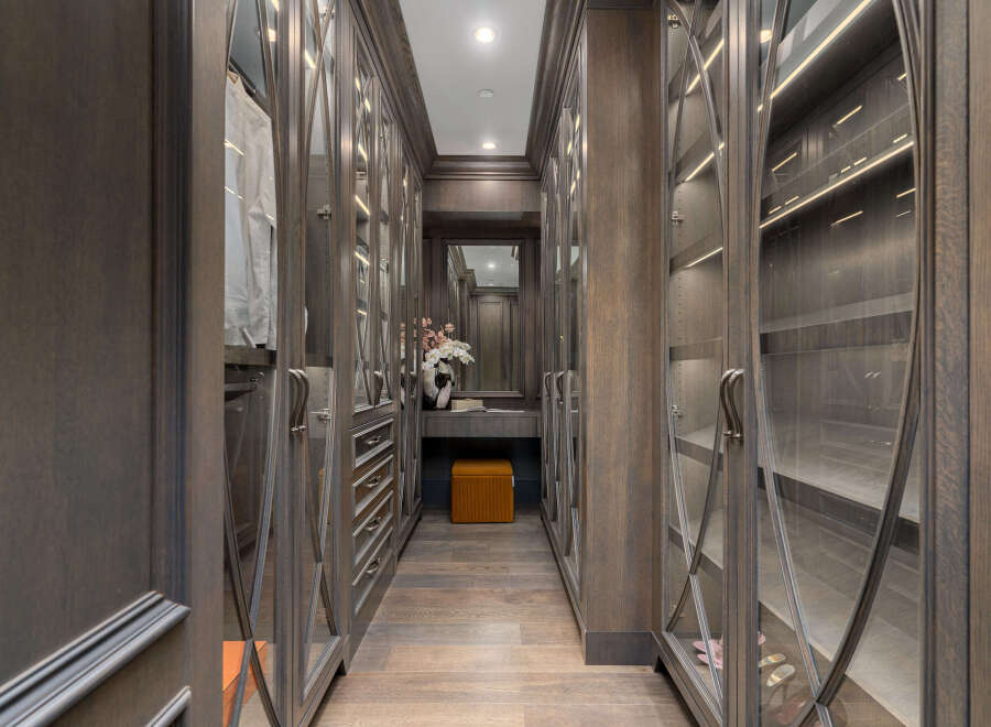 Step into luxury with this stunning walk-in closet, designed with meticulous attention to detail.