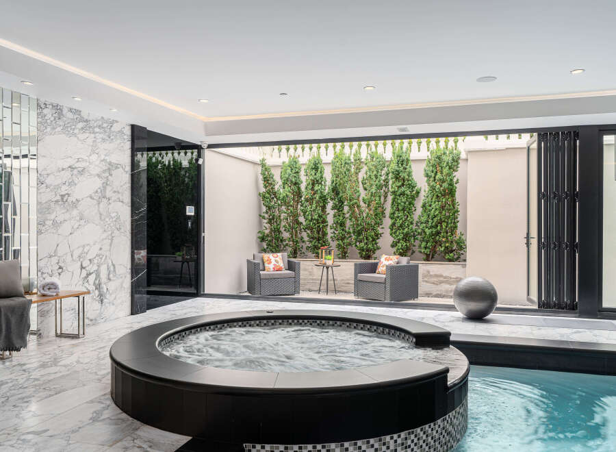Indulge in luxury with this stunning indoor spa retreat.