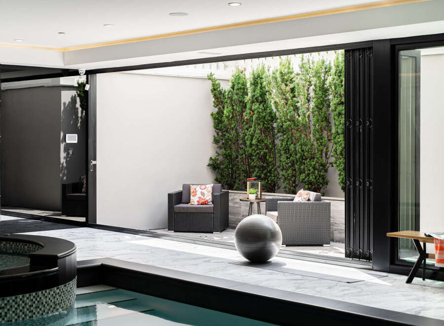 Experience luxury living with this stunning property featuring an indoor pool and a seamless transition to an outdoor patio.