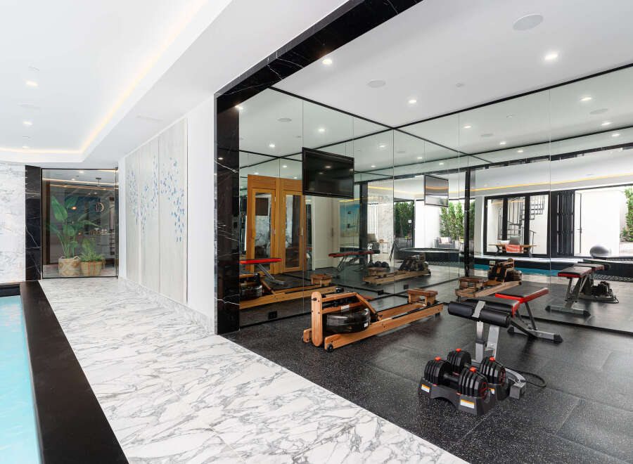 This luxurious property boasts a state-of-the-art home gym, perfect for maintaining a healthy lifestyle.