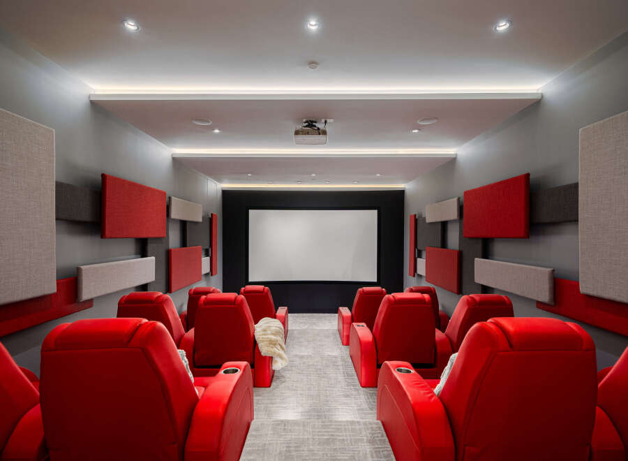 Step into luxury with this stunning home theater! Featuring plush red seating, acoustic panels, and a state-of-the-art projector, this space is perfect for movie nights and entertaining.
