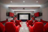 Step into luxury with this stunning home theater! Featuring plush red seating, acoustic panels, and a state-of-the-art projector, this space is perfect for movie nights and entertaining.