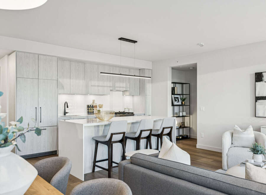 Experience modern living in this stunning kitchen! Featuring sleek cabinetry, a spacious island with seating, and high-end appliances, this kitchen is perfect for both cooking and entertaining.